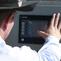 Cowboy Using A Touchscreen Control Box For A Panel Walker